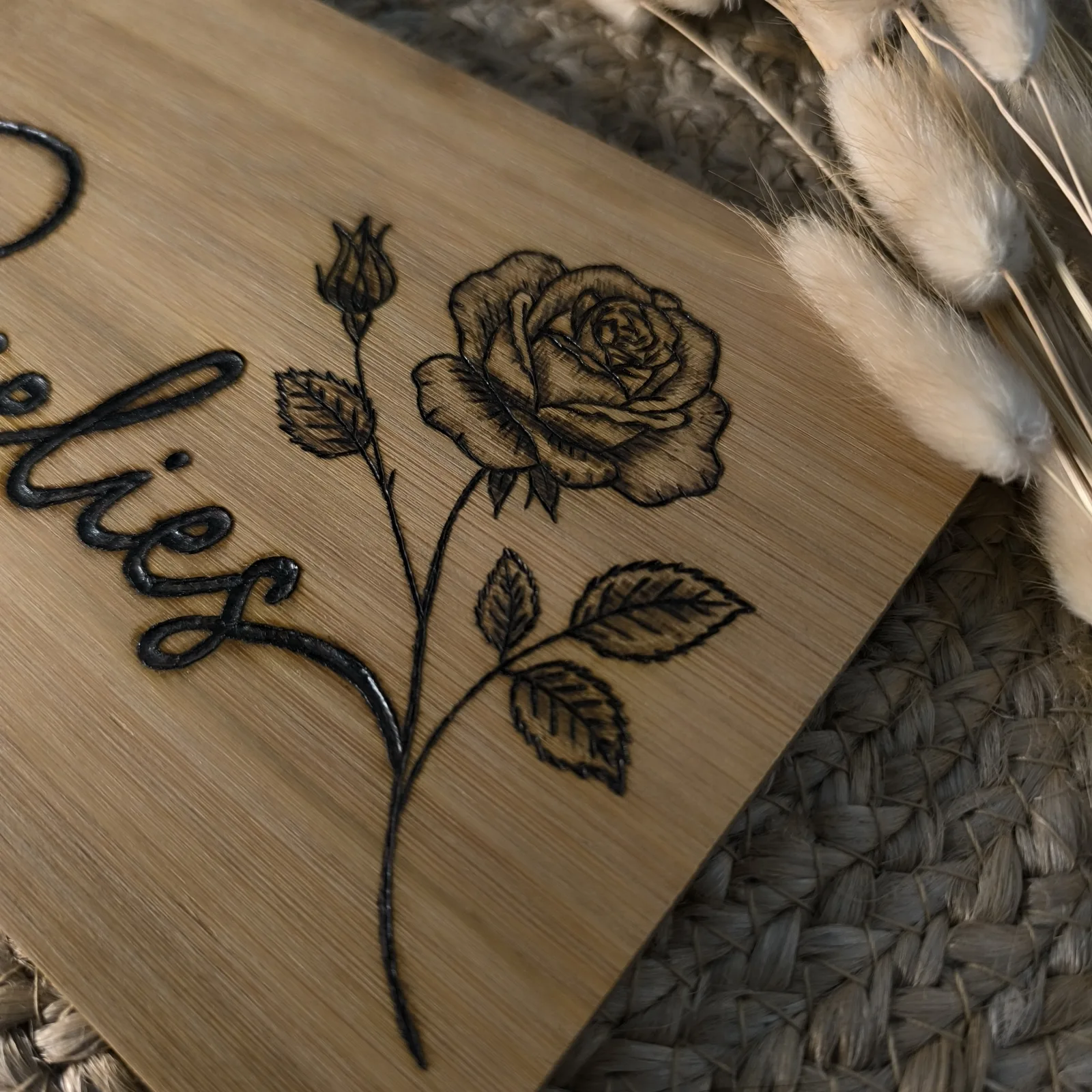 Detailansicht des Bambusbrettchens mit eingebrannter Rose und dem Namen Roselies.